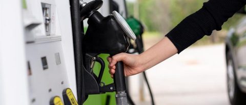 Woman fills up her Cadillac with gas