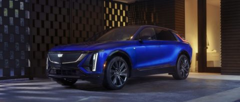 Opulent Blue Metallic Cadillac LYRIQ parked at a modern home.